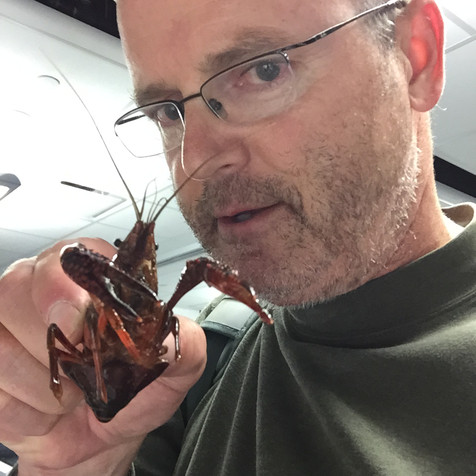 Dr. Mike Kavanaugh holding a crawfish.